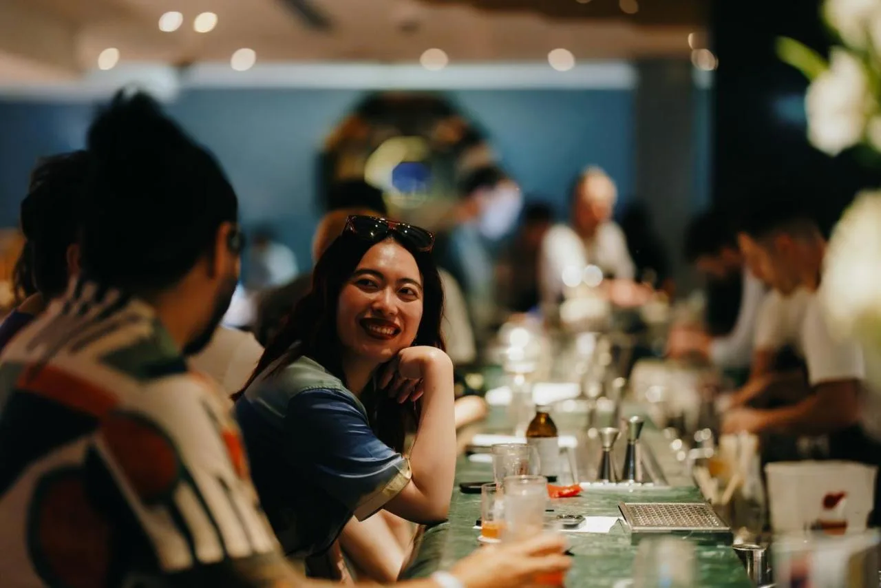 a woman sitting at a table in a restaurant at Sea Containers London in London