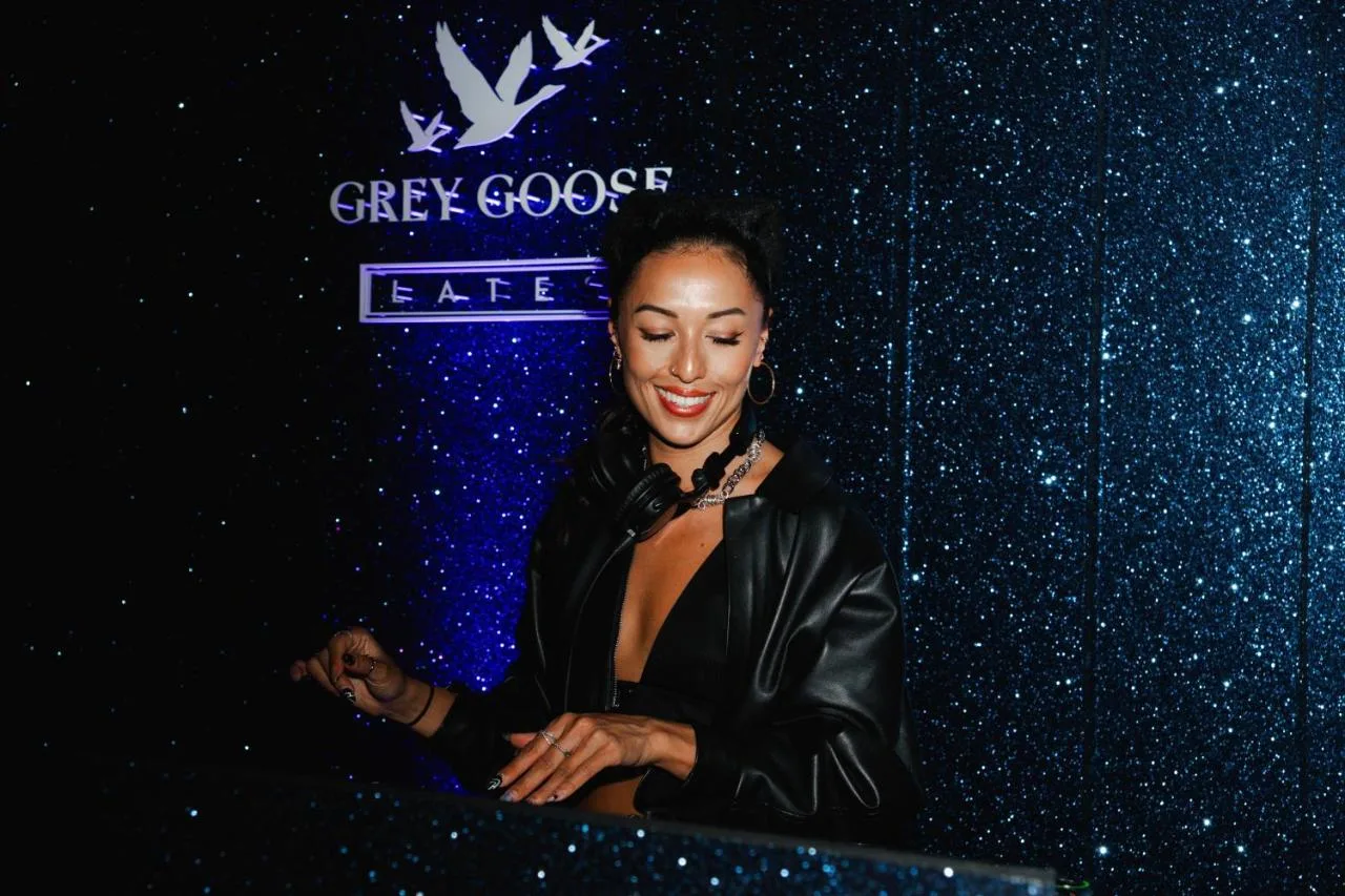 a woman in a leather jacket standing at a podium at Sea Containers London in London