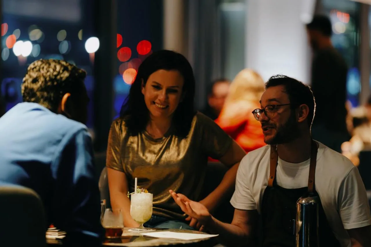 a man and woman sitting at a table in a restaurant at Sea Containers London in London